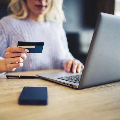 Woman Shopping On Laptop While Holding Her Credit Card